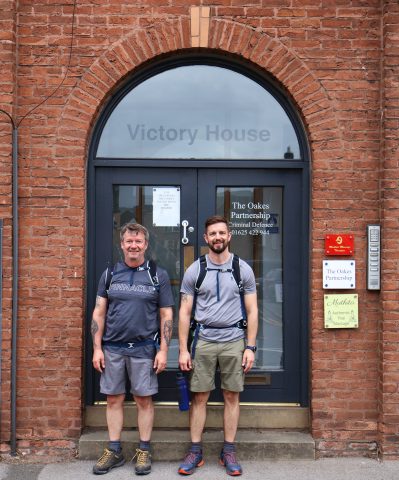 Dave and Coach Sean stand infront of the ISL head office doors in Macclesfield